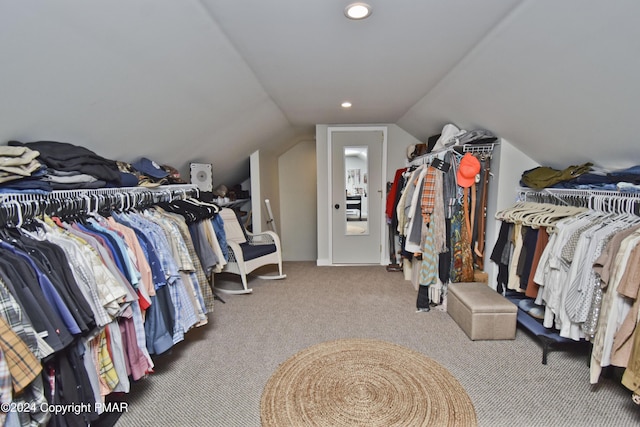 walk in closet with lofted ceiling and carpet floors