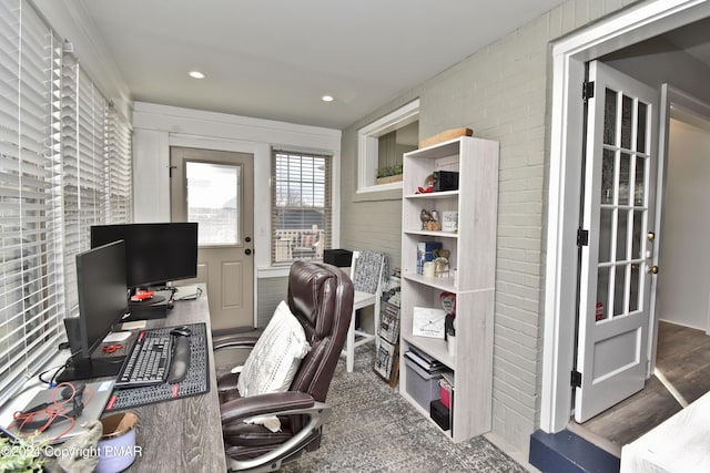 home office featuring brick wall, wood finished floors, and recessed lighting