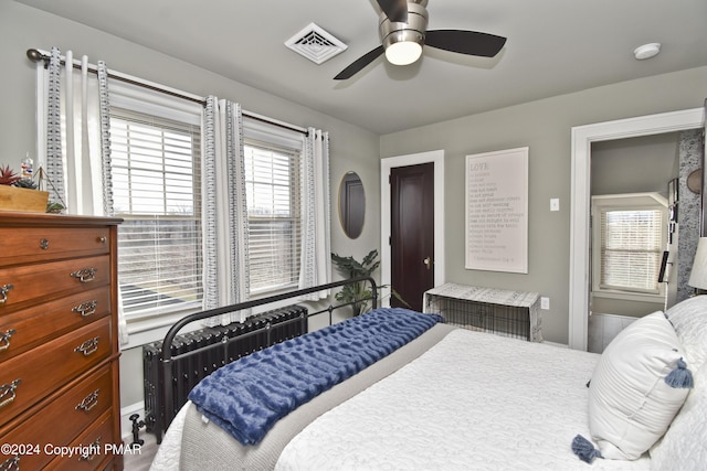 bedroom featuring ceiling fan, visible vents, and radiator