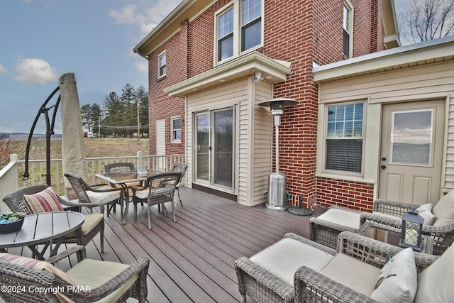 wooden terrace with outdoor dining area