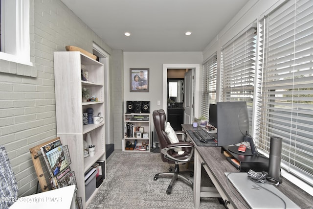 office area with recessed lighting and brick wall