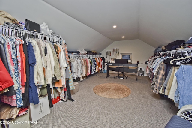 walk in closet with lofted ceiling and carpet