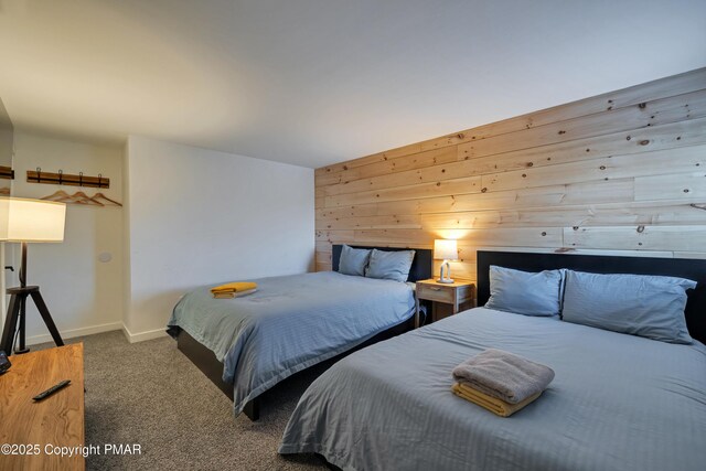 bedroom featuring dark carpet and wood walls