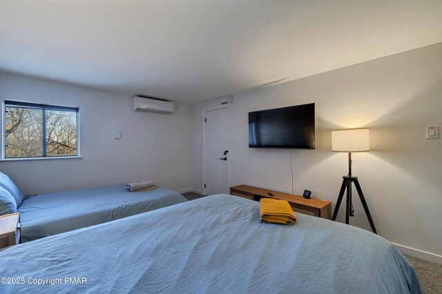 bedroom featuring a wall mounted AC and carpet flooring