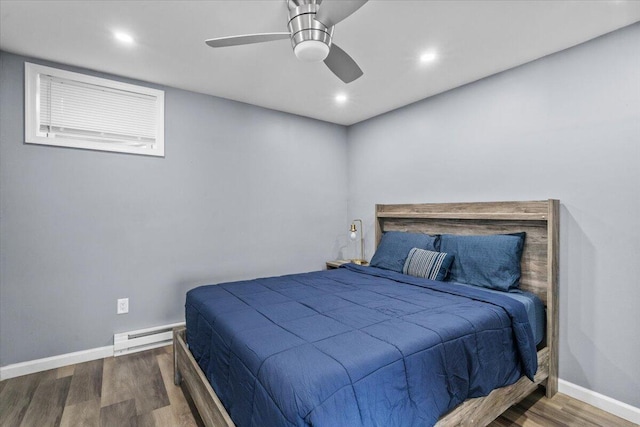 bedroom with ceiling fan, recessed lighting, baseboard heating, wood finished floors, and baseboards