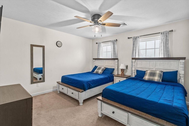 bedroom featuring visible vents, ceiling fan, carpet flooring, and baseboards