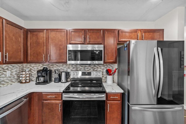 kitchen featuring backsplash, light stone countertops, and stainless steel appliances