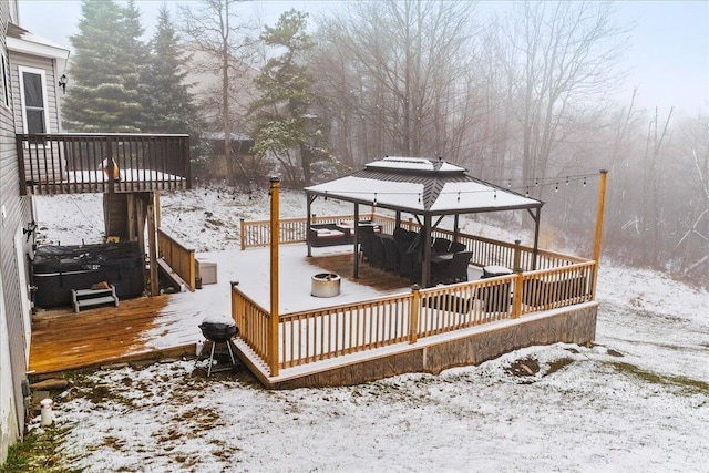 snow covered deck featuring a gazebo
