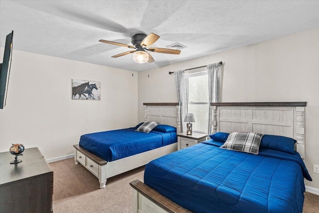 bedroom featuring baseboards, carpet flooring, a textured ceiling, a ceiling fan, and visible vents