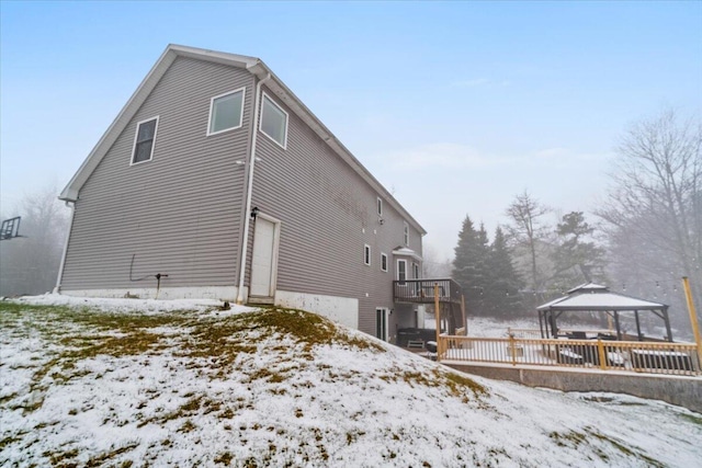 view of snow covered exterior with a gazebo