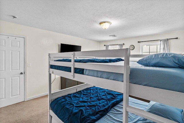 bedroom featuring carpet and a textured ceiling