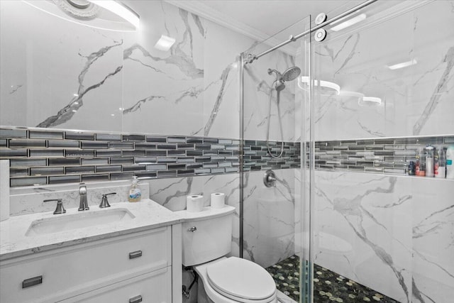bathroom featuring vanity, ornamental molding, toilet, tile walls, and a marble finish shower