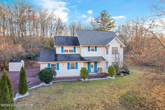 traditional-style home with an outbuilding and a front yard