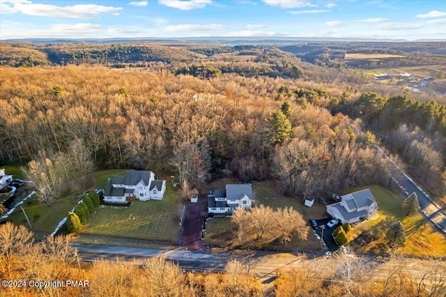 birds eye view of property featuring a view of trees