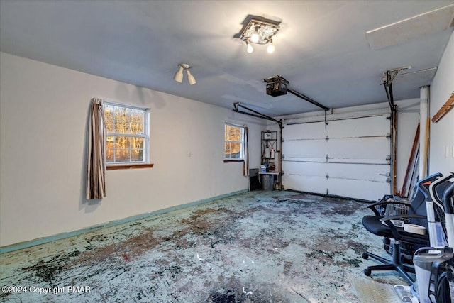 garage with a garage door opener and baseboards