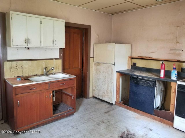 kitchen featuring white appliances, white cabinets, a sink, and light floors