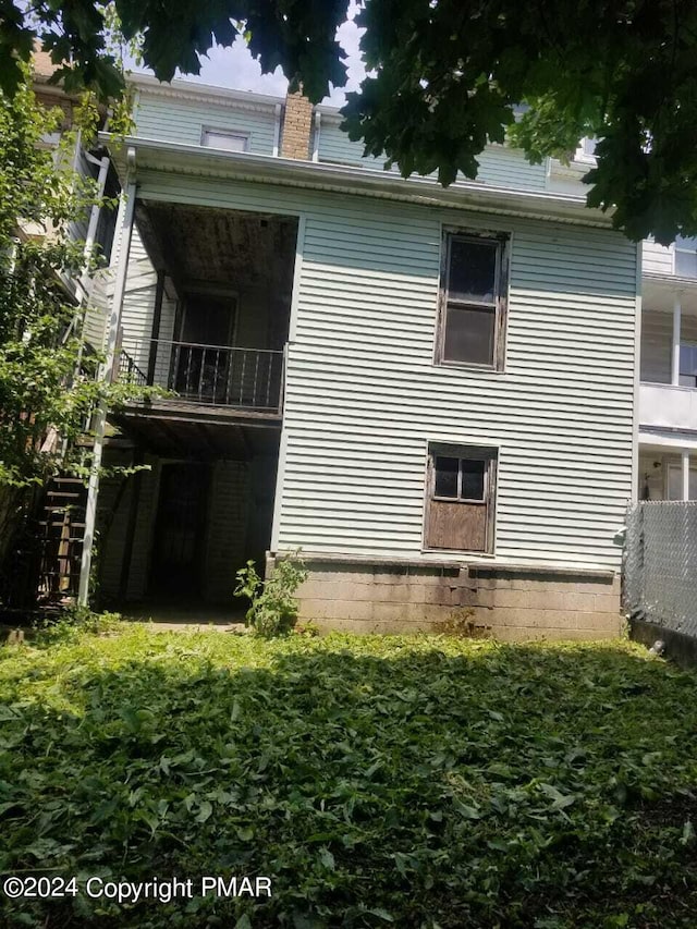 view of side of home with a balcony