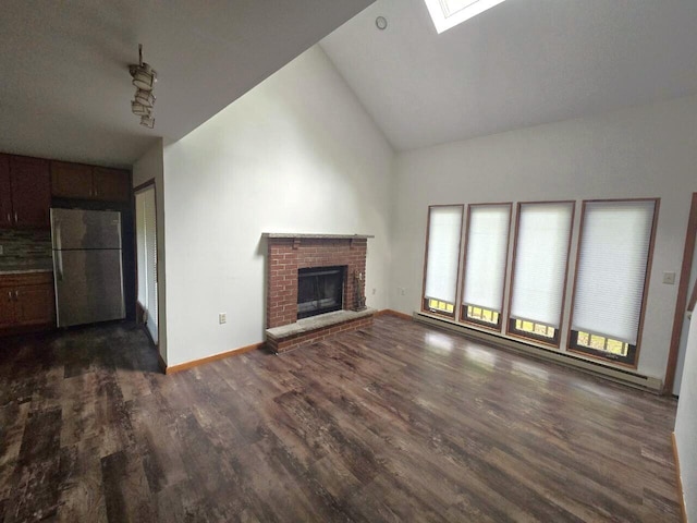 3221 Windermere Dr, Bushkill, PA 18324 - unfurnished living room featuring dark wood finished floors, lofted ceiling, a brick fireplace, and a skylight