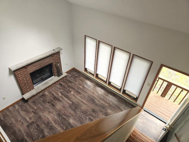 3221 Windermere Dr, Bushkill, PA 18324 - unfurnished living room with a brick fireplace and wood finished floors