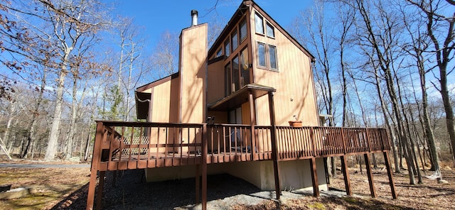 3221 Windermere Dr, Bushkill, PA 18324 - rear view of property with a deck and a chimney