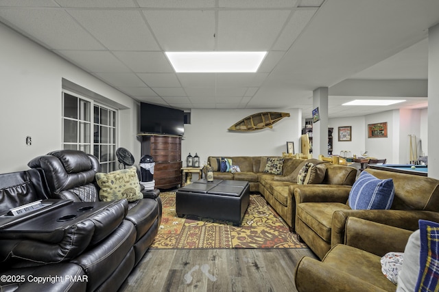 living room featuring hardwood / wood-style floors and a paneled ceiling