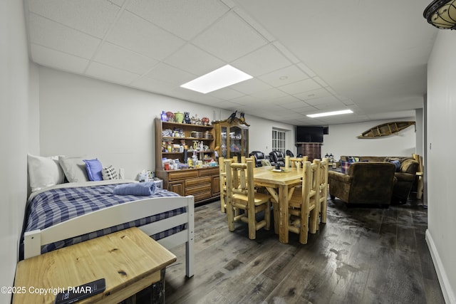 dining room featuring a paneled ceiling and dark hardwood / wood-style floors