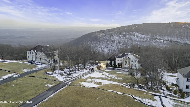 snowy aerial view with a mountain view