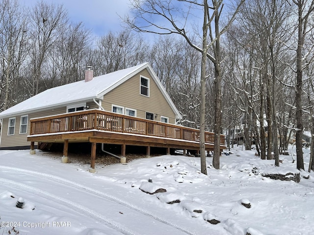 view of front of home featuring a chimney and a wooden deck