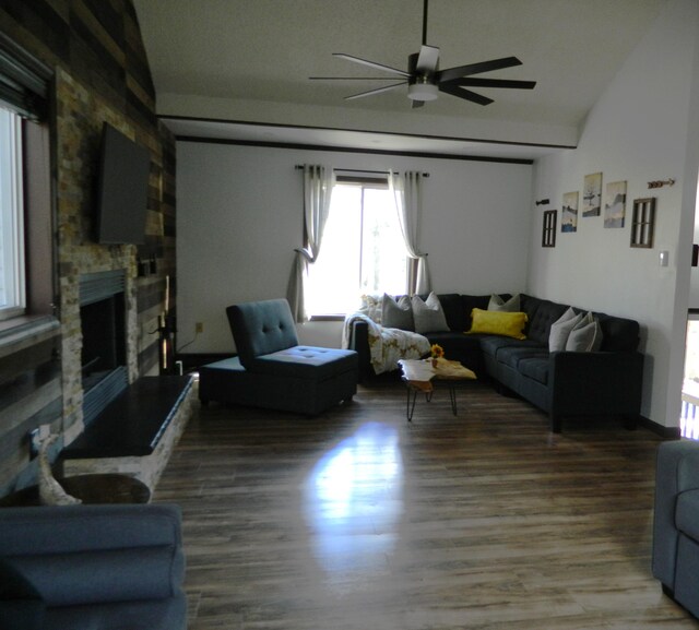 7086 Boulder Ct, Tobyhanna, PA 18466 - living area featuring a ceiling fan, a stone fireplace, wood finished floors, and vaulted ceiling