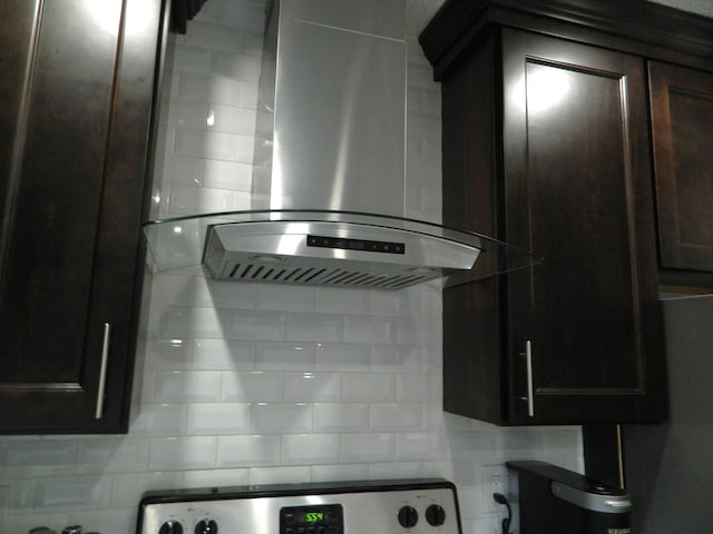 7086 Boulder Ct, Tobyhanna, PA 18466 - kitchen view of wall chimney range hood, backsplash, dark brown cabinetry, and stove