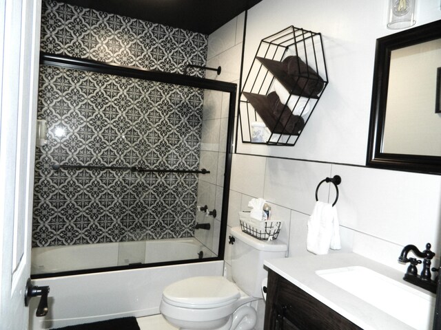 7086 Boulder Ct, Tobyhanna, PA 18466 - bathroom featuring toilet, vanity, enclosed tub / shower combo, and tile walls