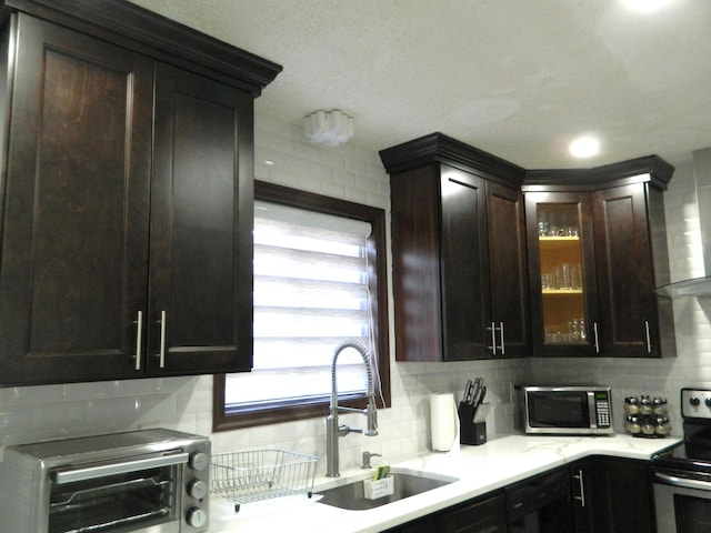 7086 Boulder Ct, Tobyhanna, PA 18466 - kitchen featuring stainless steel appliances, decorative backsplash, a sink, and glass insert cabinets