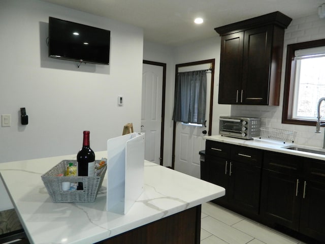 7086 Boulder Ct, Tobyhanna, PA 18466 - kitchen with a sink, light stone countertops, and decorative backsplash