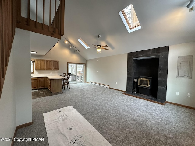 living room with a baseboard radiator, high vaulted ceiling, a skylight, and dark carpet