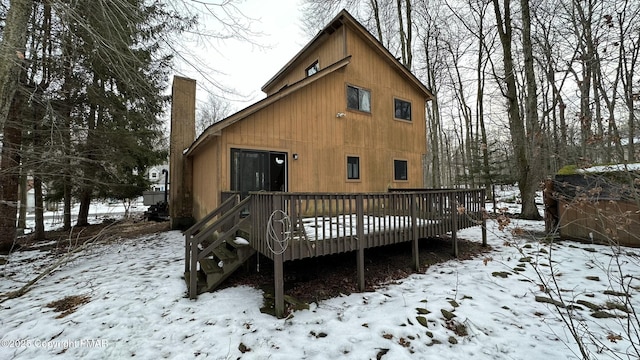 snow covered property featuring a deck