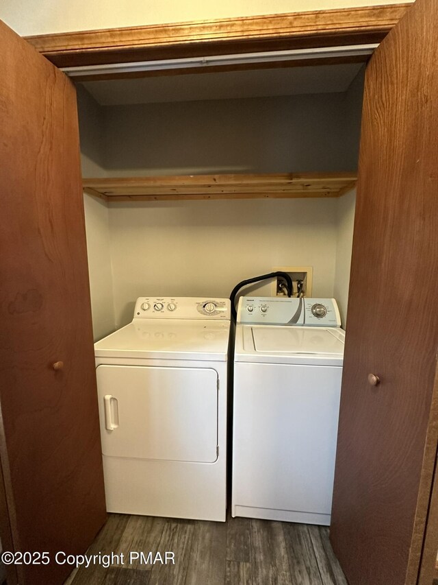 laundry area with separate washer and dryer and dark hardwood / wood-style floors