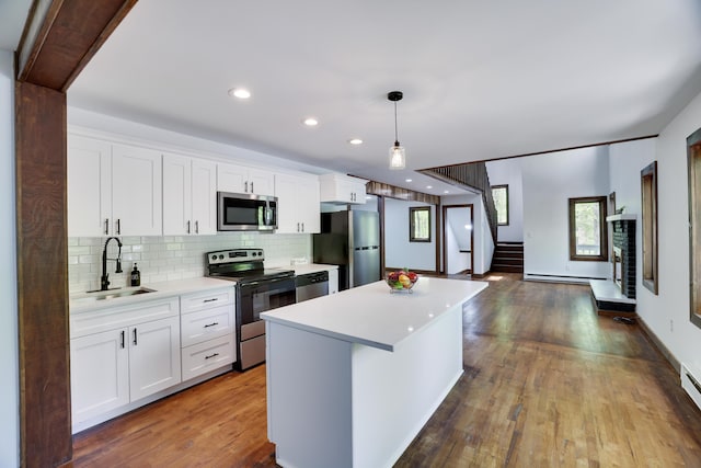 8210 Pine Grove Dr, East Stroudsburg, PA 18301 - kitchen featuring appliances with stainless steel finishes, a sink, a baseboard radiator, a center island, and light countertops