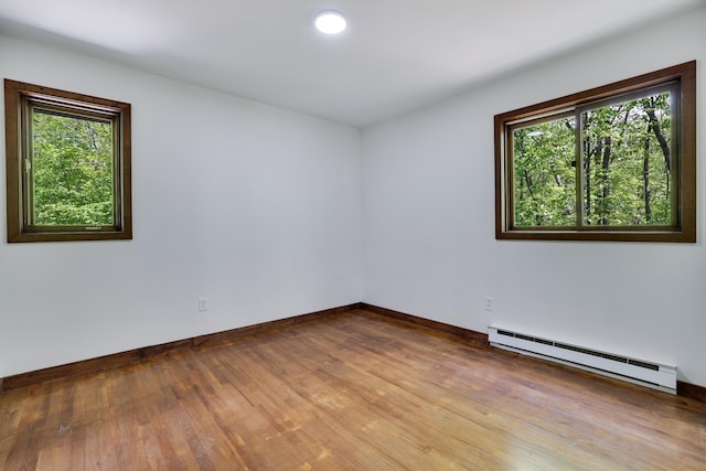 8210 Pine Grove Dr, East Stroudsburg, PA 18301 - empty room with a baseboard radiator, wood finished floors, and baseboards