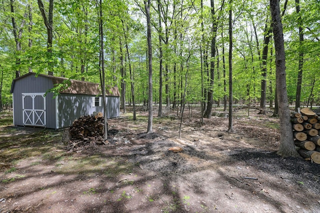 8210 Pine Grove Dr, East Stroudsburg, PA 18301 - view of yard with an outdoor structure, a storage shed, and a wooded view