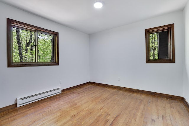 8210 Pine Grove Dr, East Stroudsburg, PA 18301 - unfurnished room featuring a baseboard heating unit, healthy amount of natural light, light wood-style flooring, and baseboards