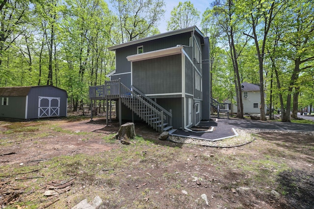 8210 Pine Grove Dr, East Stroudsburg, PA 18301 - rear view of property with stairs, a shed, an outbuilding, and a deck