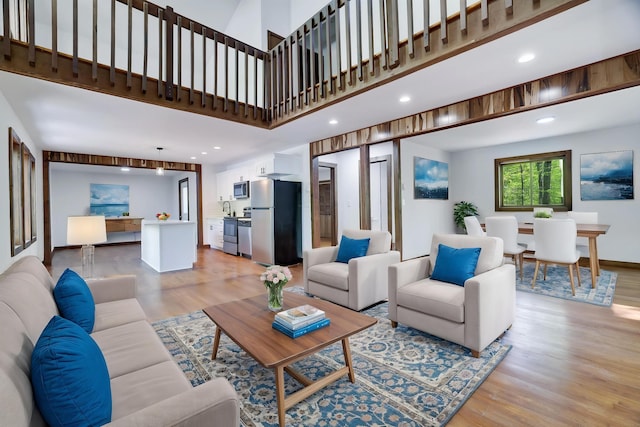 8210 Pine Grove Dr, East Stroudsburg, PA 18301 - living room featuring light wood-style flooring, recessed lighting, and a towering ceiling