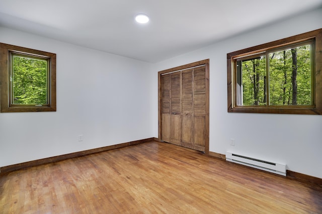 8210 Pine Grove Dr, East Stroudsburg, PA 18301 - unfurnished bedroom featuring a baseboard radiator, light wood-style floors, baseboards, a closet, and recessed lighting