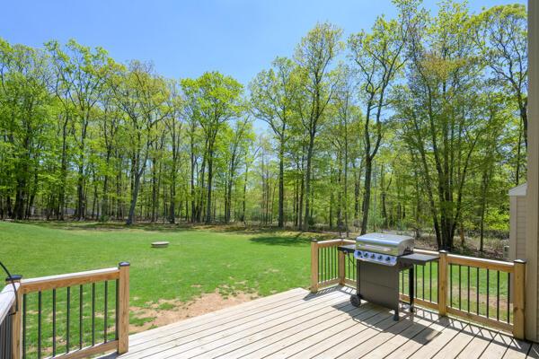 deck featuring a grill and a yard