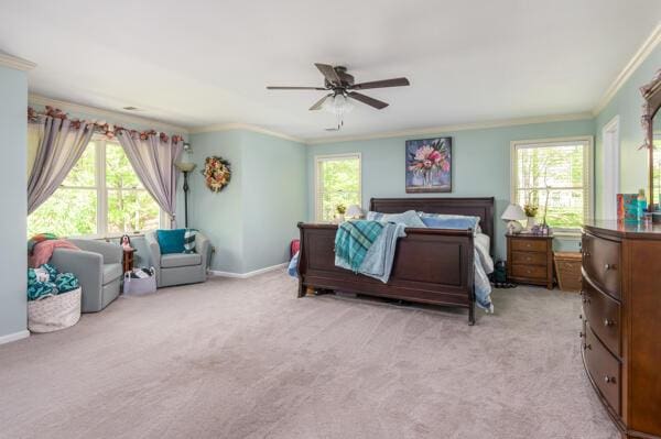 bedroom with crown molding, multiple windows, light carpet, a ceiling fan, and baseboards