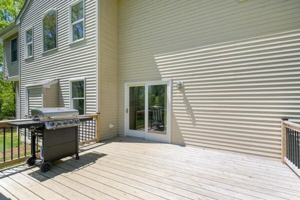 wooden deck featuring area for grilling