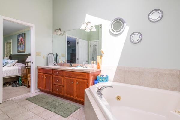ensuite bathroom featuring double vanity, a whirlpool tub, tile patterned floors, and a chandelier