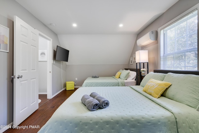 bedroom featuring lofted ceiling, a wall unit AC, recessed lighting, dark wood-type flooring, and baseboards