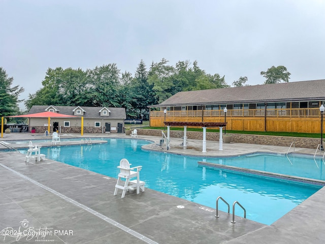 pool with fence and a patio