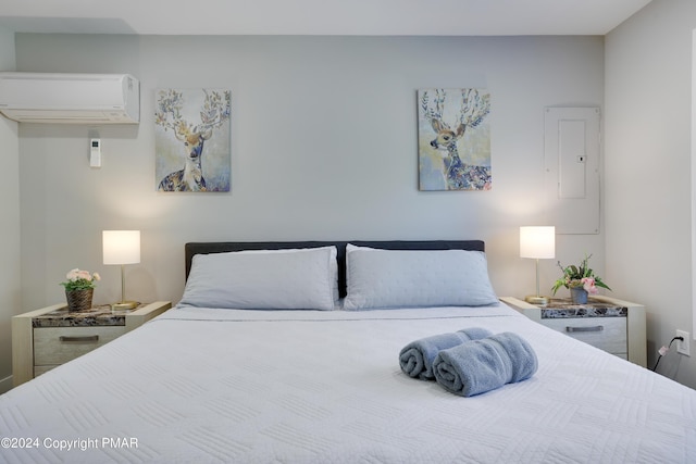 bedroom featuring an AC wall unit and electric panel